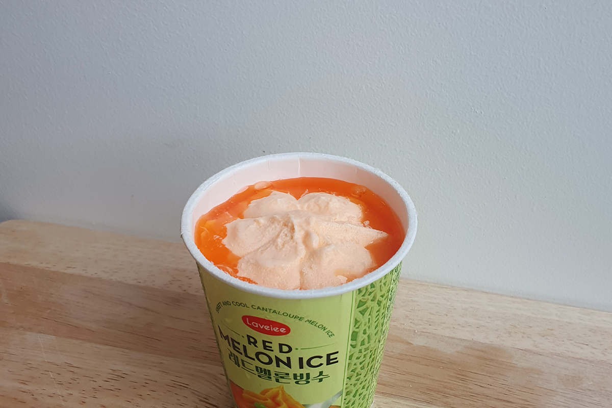 Red melon ice opened lid on a wooden tray
