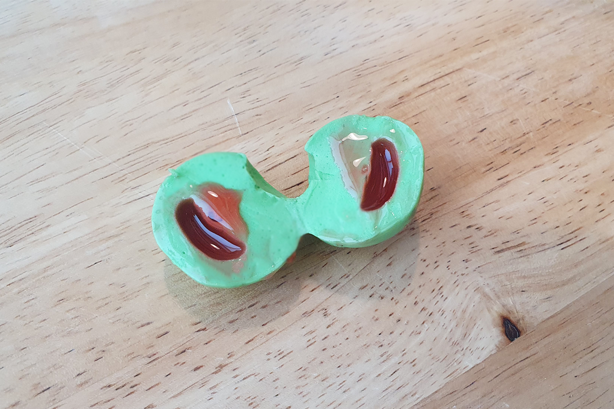 round watermelon jelly cut in half on a wooden tray
