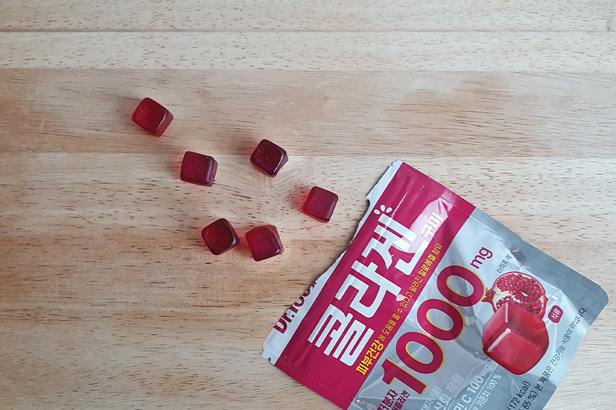 Dr. You collagen gummy red cubes on the wooden tray