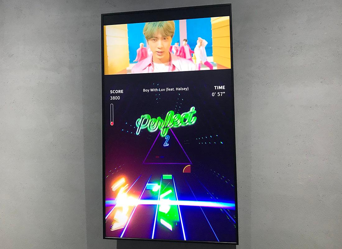 Large screen featuring music from Boy with Luv by BTS