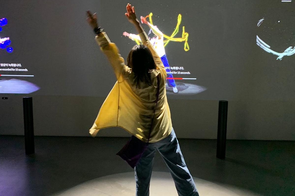 Visitor interacting with video exhibition