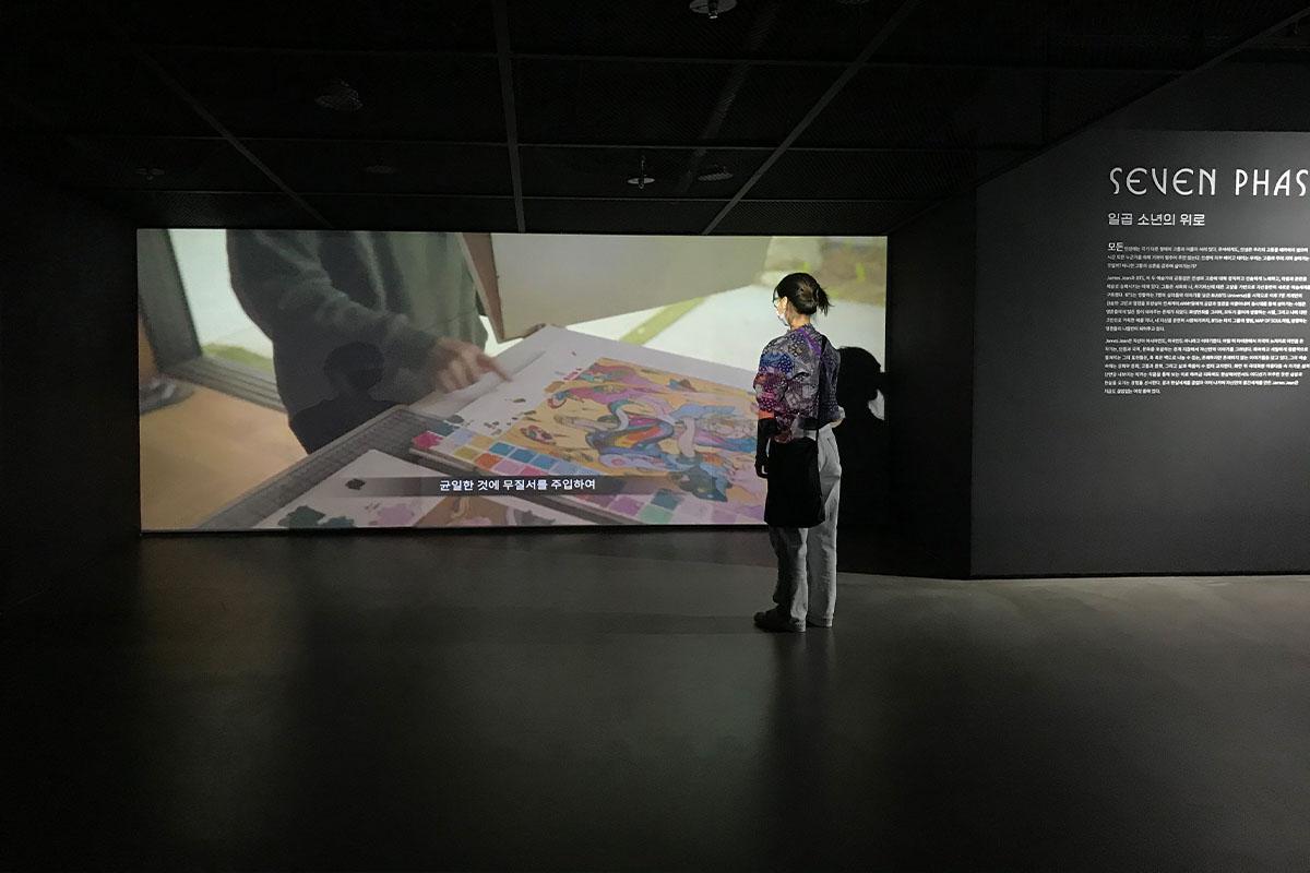 Visitor watching video about the exhibition