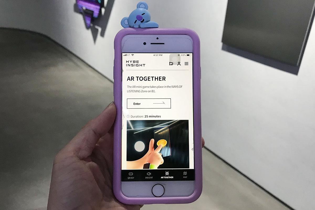 Visitor engaging with augmented reality game on phone