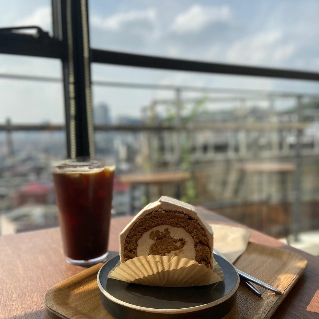 coffee and dessert served on a wooden table at Cafe Moonee rooftop