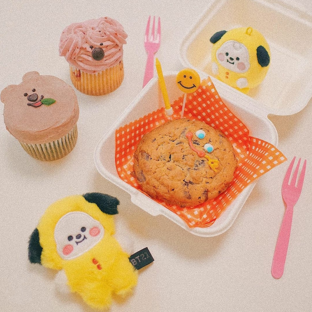 BT21 toy, cookies, and desserts on the table at Cafe Skön