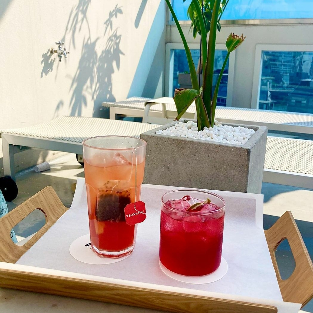 drinks served on a wooden tray at Designery Cafe rooftop