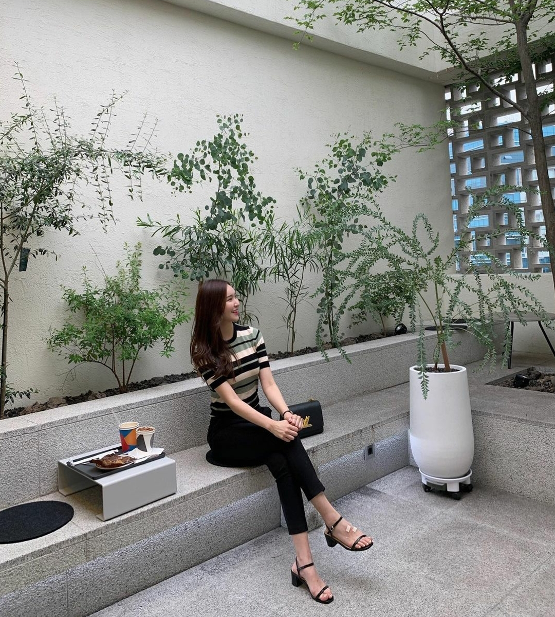 girl sitting at Cafe Yeonmujang with legs crossed looking up