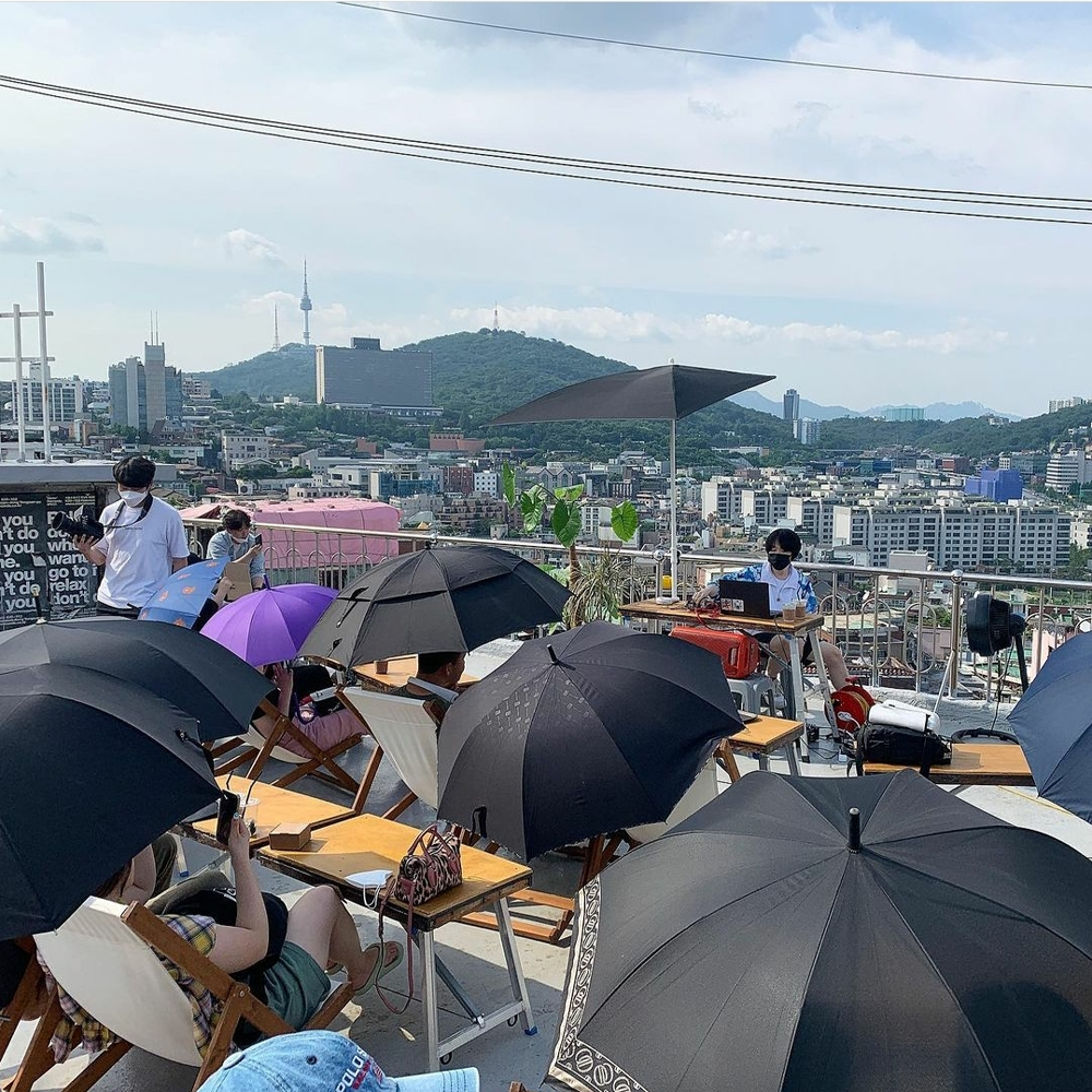 Koreans with umbrellas at Mmm Records rooftop