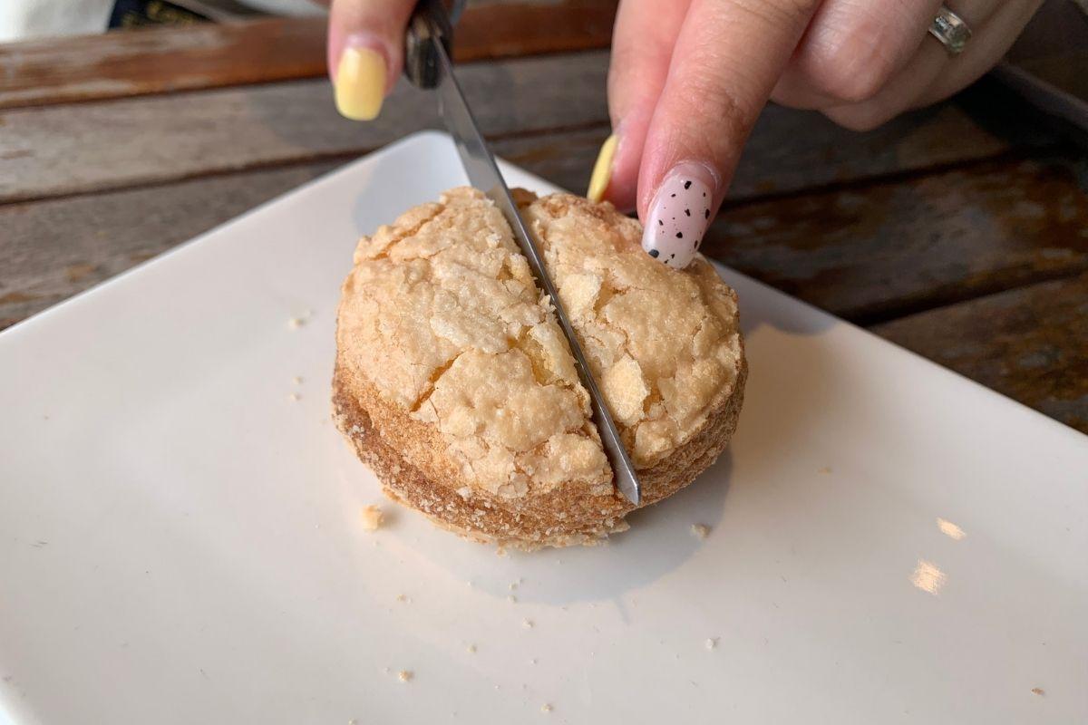 Cheese dacquoise being cut in half