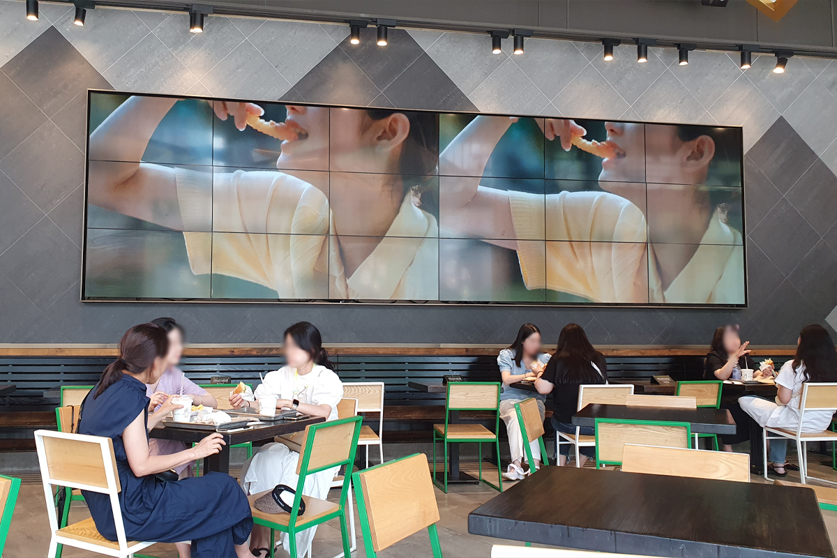 Large screen featuring promotional videos at Shake Shack