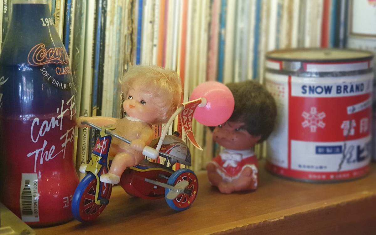 Close up shot of toys and trinkets featured in display case at restaurant bar in Seoul
