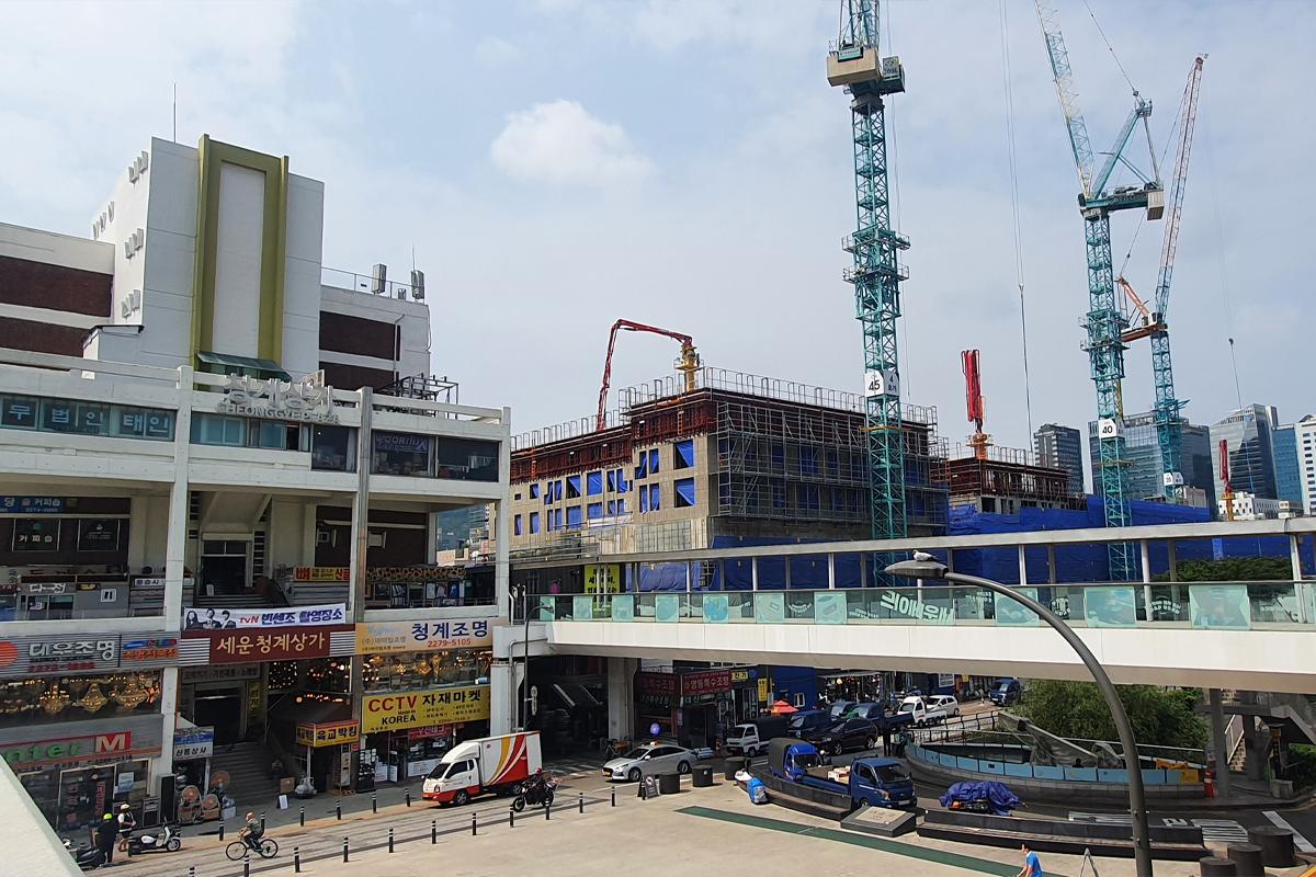 Pan out shot of shopping center and construction sight in Seoul