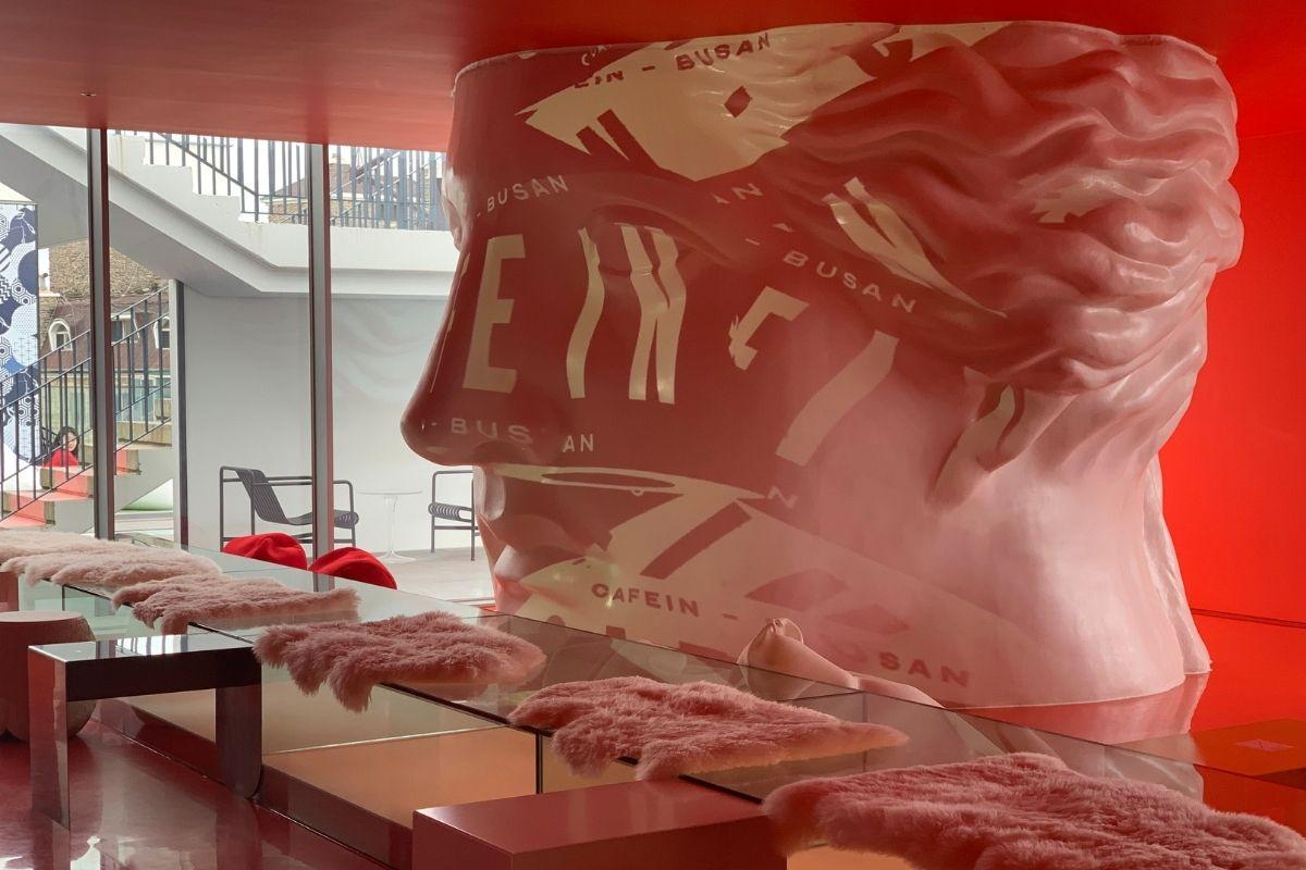 Cafe In Busan white sculpture in red projector lights