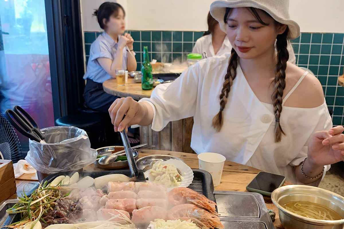 Customer grilling at restaurant table