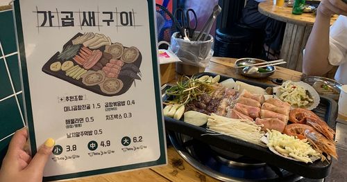 Menu of grilled tripe restaurant in Busan next to grill on table