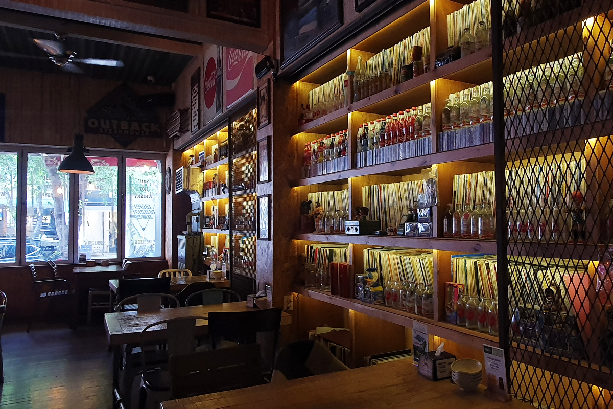 Seating area of bar featuring display of vinyl records