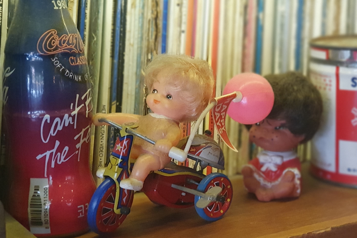 Close-up shot of vintage Coca-Cola bottle and toys