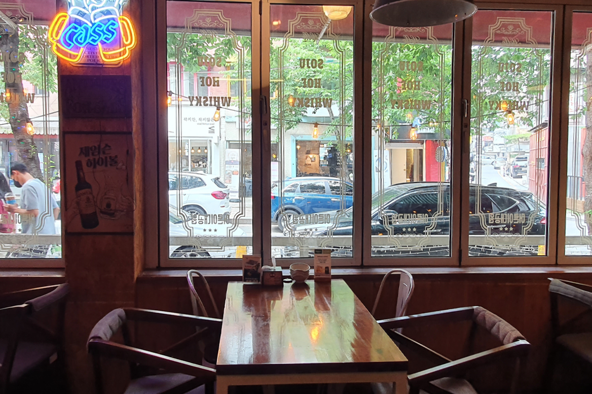 Seating area near window at Adult Grand Park bar in Seoul