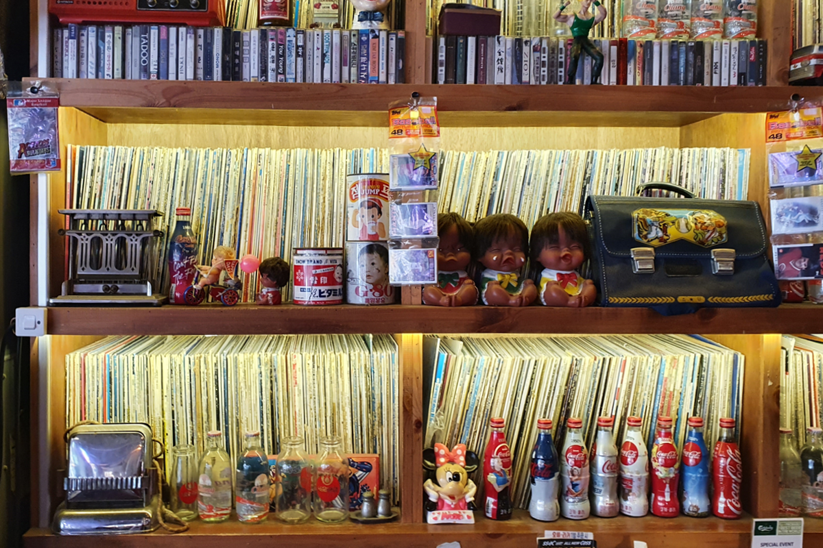 Close-up shot of vinyl records display with various toys and trinkets