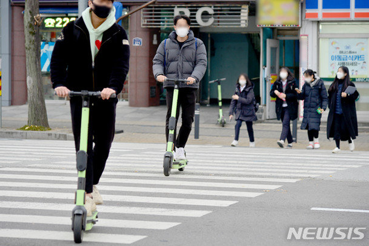 people riding electric scooters in Korea