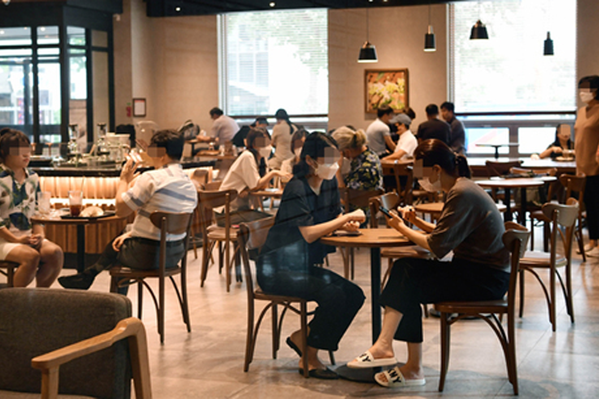 Koreans wearing a mask at a cafe