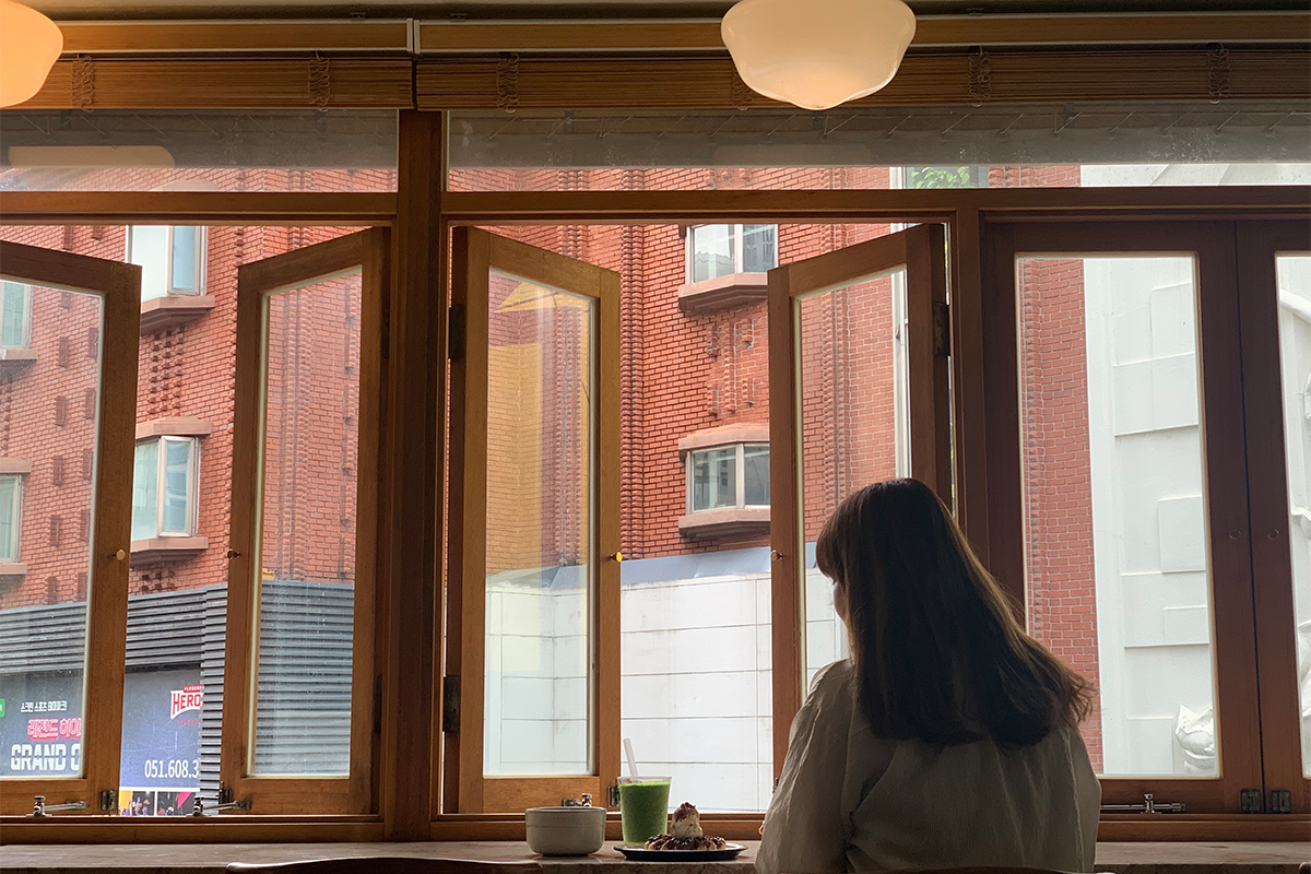 Girl looking out the window at Modern Table Cafe in Busan