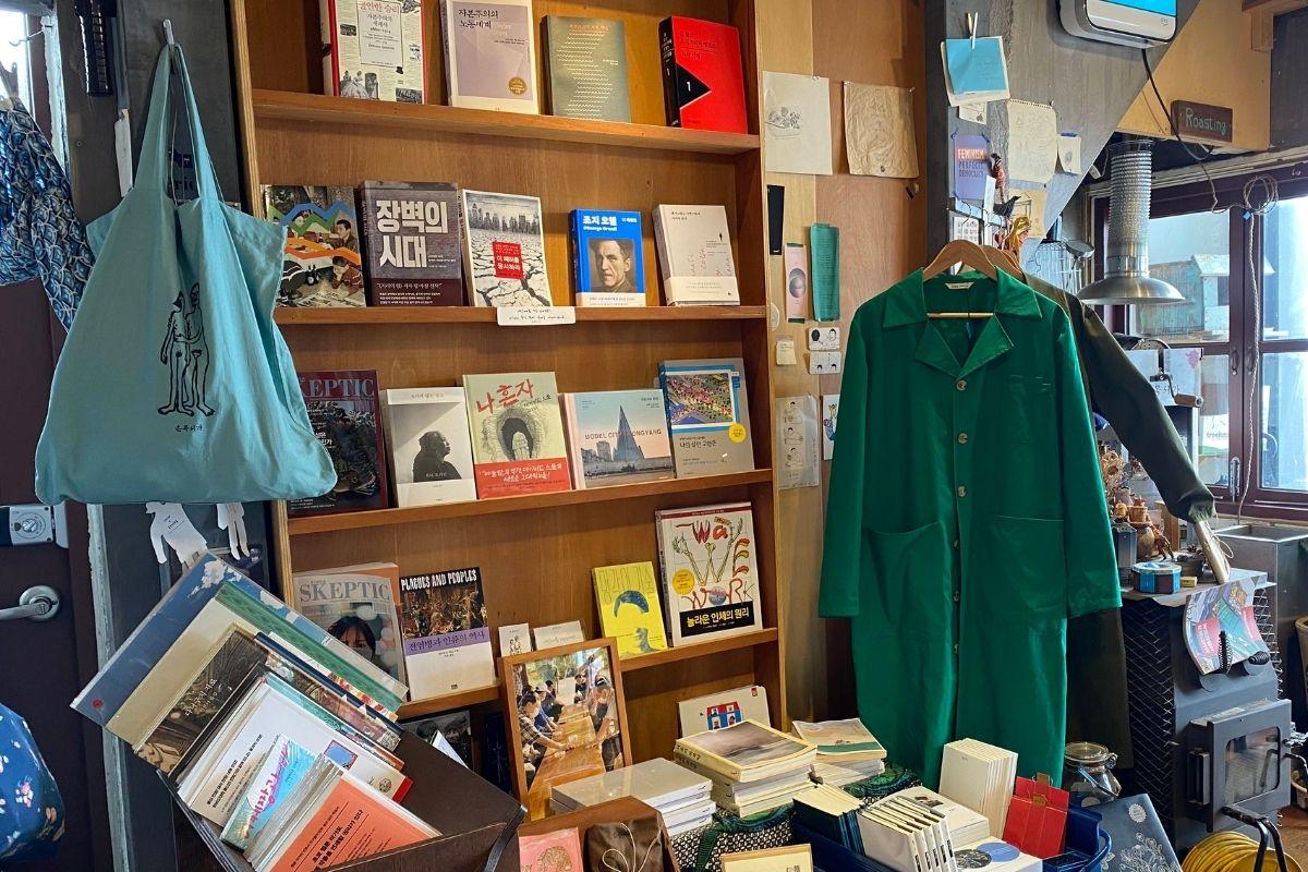Sonmokseoga cafe, Huinnyeoul Culture Village, Busan, Korea, interior, clothes, bags, shelves, books