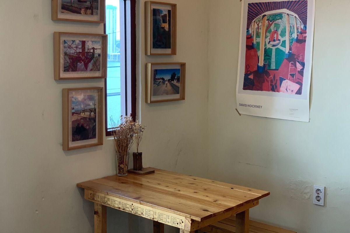 interior, wooden table and chairs, paintings on wall, dried flowers, Sonmokseoga cafe, Huinnyeoul Culture Village, Busan, Korea
