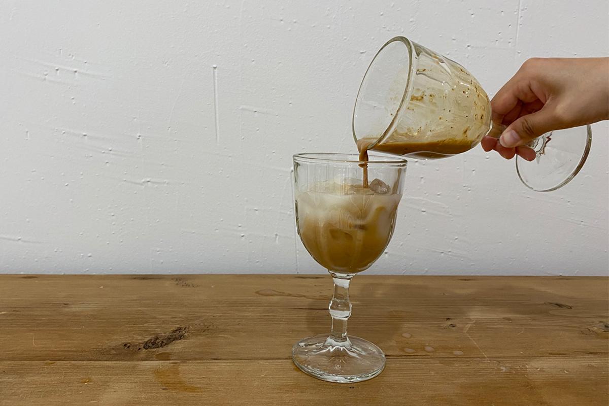Pouring makegolli into cup with coffee mix