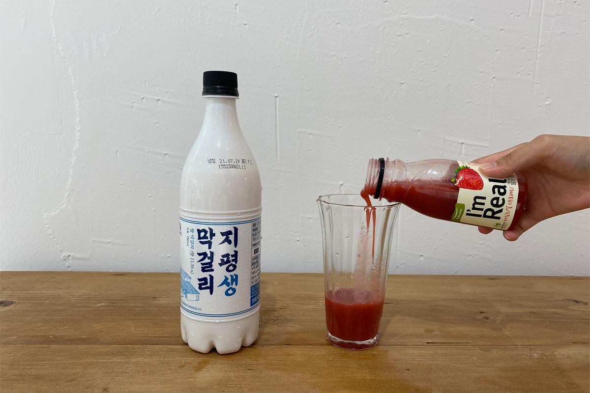 Pouring strawberry juice into cup