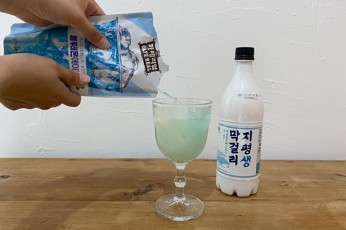 Pouring blue lemonade into glass