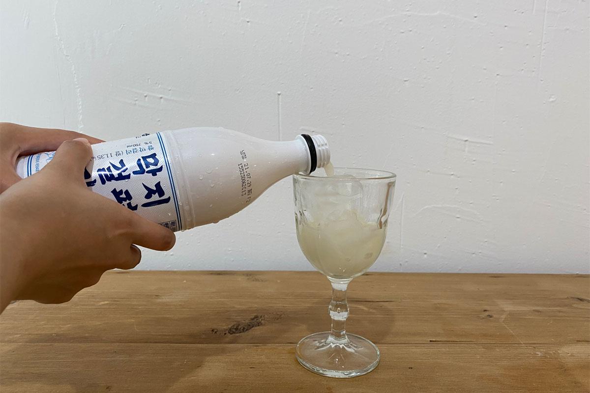 Pouring makgeolli into glass