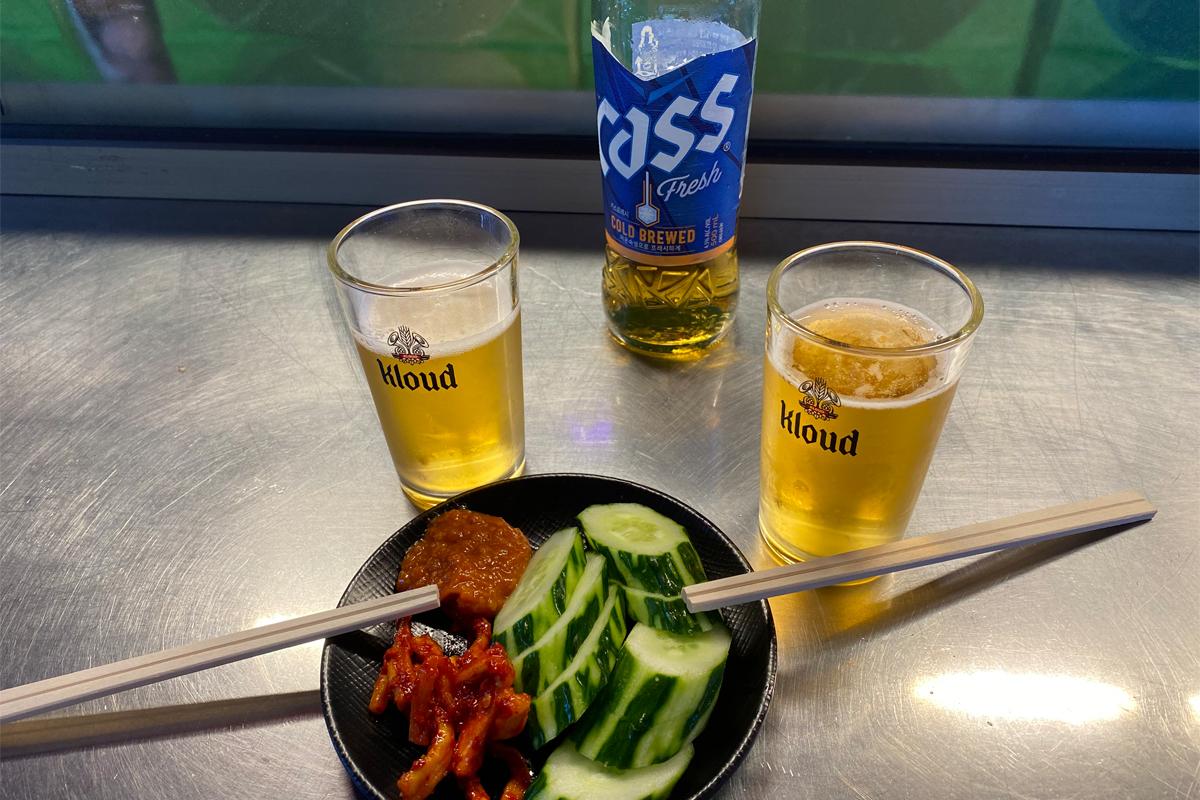 Busan Korea Seomyeon Pojangmacha Street, drinking beer, cucumber and dried radish appetizer