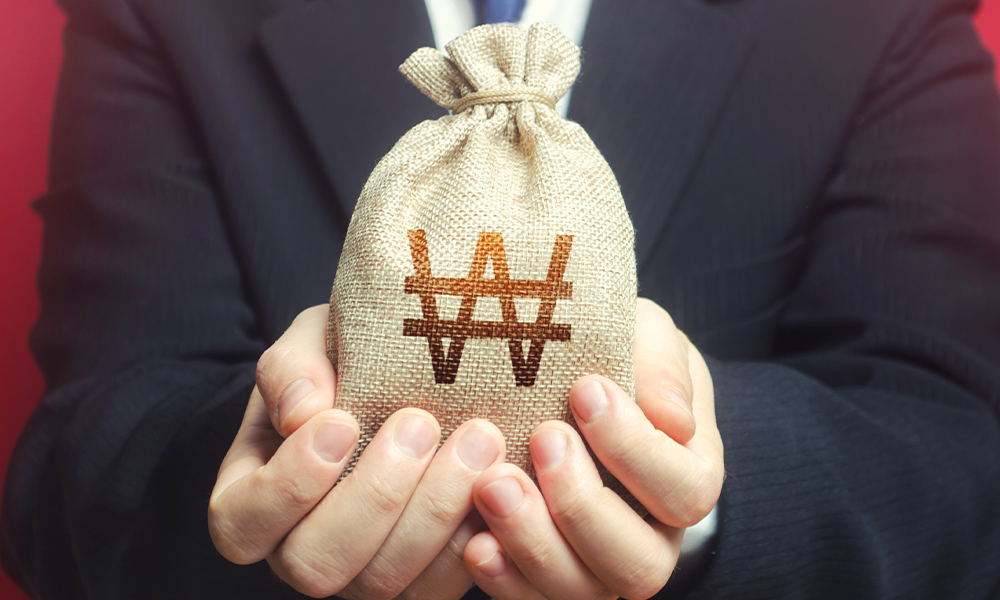man in a suit with a bag of money in his hands