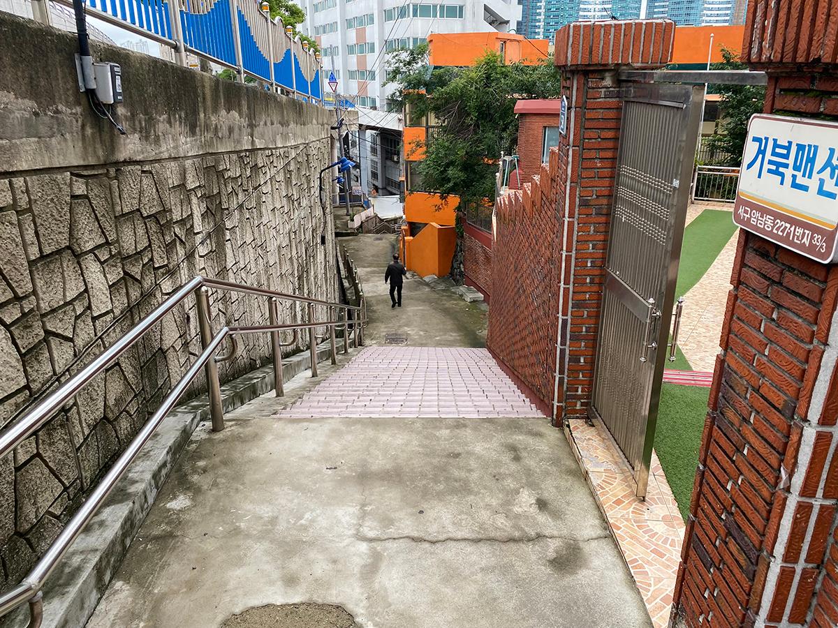 Alleys of Songdo Beach with a bright orange building in the background