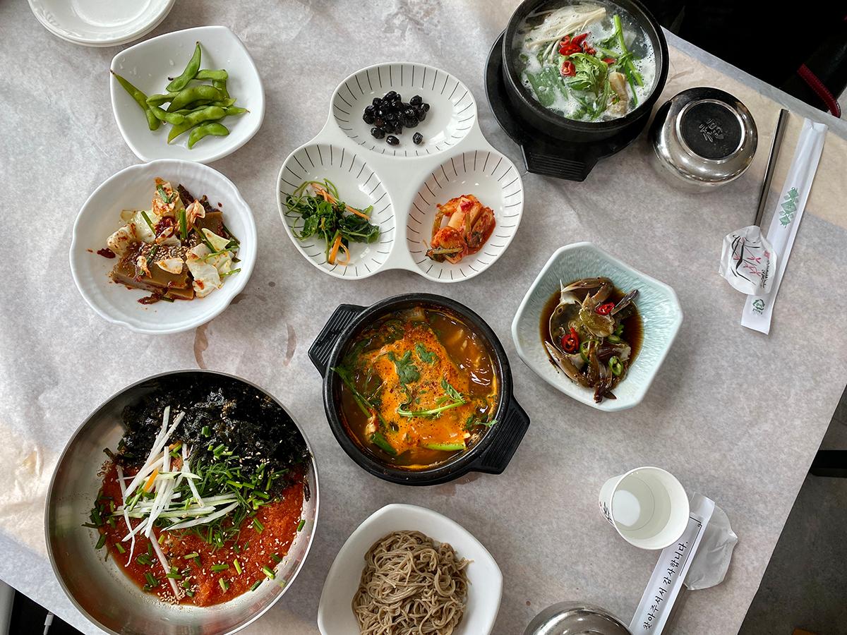 A high angle shot of all the colourful dishes served at a restaurant in Busan