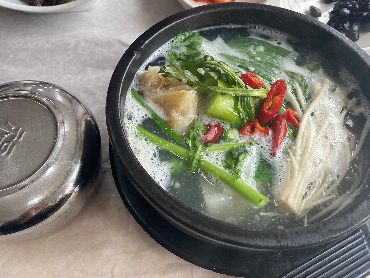 Daegutang (cod fish soup) served in a black pot in Busan