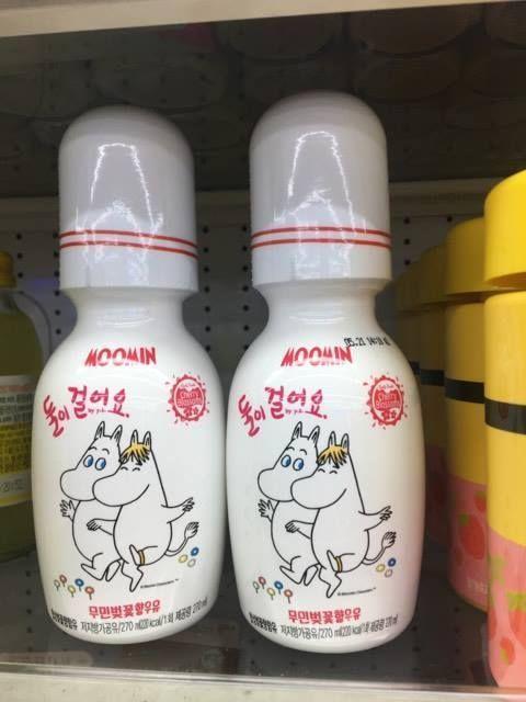 Close-up of Moomin milk bottles with playful designs available at GS25 in Korea