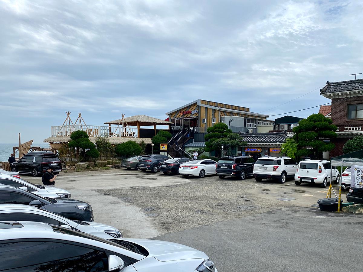 A parking lot filled with cars at Haeundae Haemul Kalguksu in Gijang, Busan