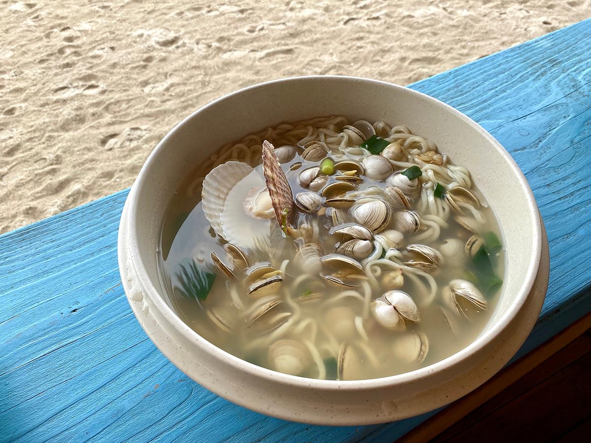 Haeundae Haemul Kalguksu on a bright blue table at Haeundae Haemul Kalguksu in Gijang, Busan