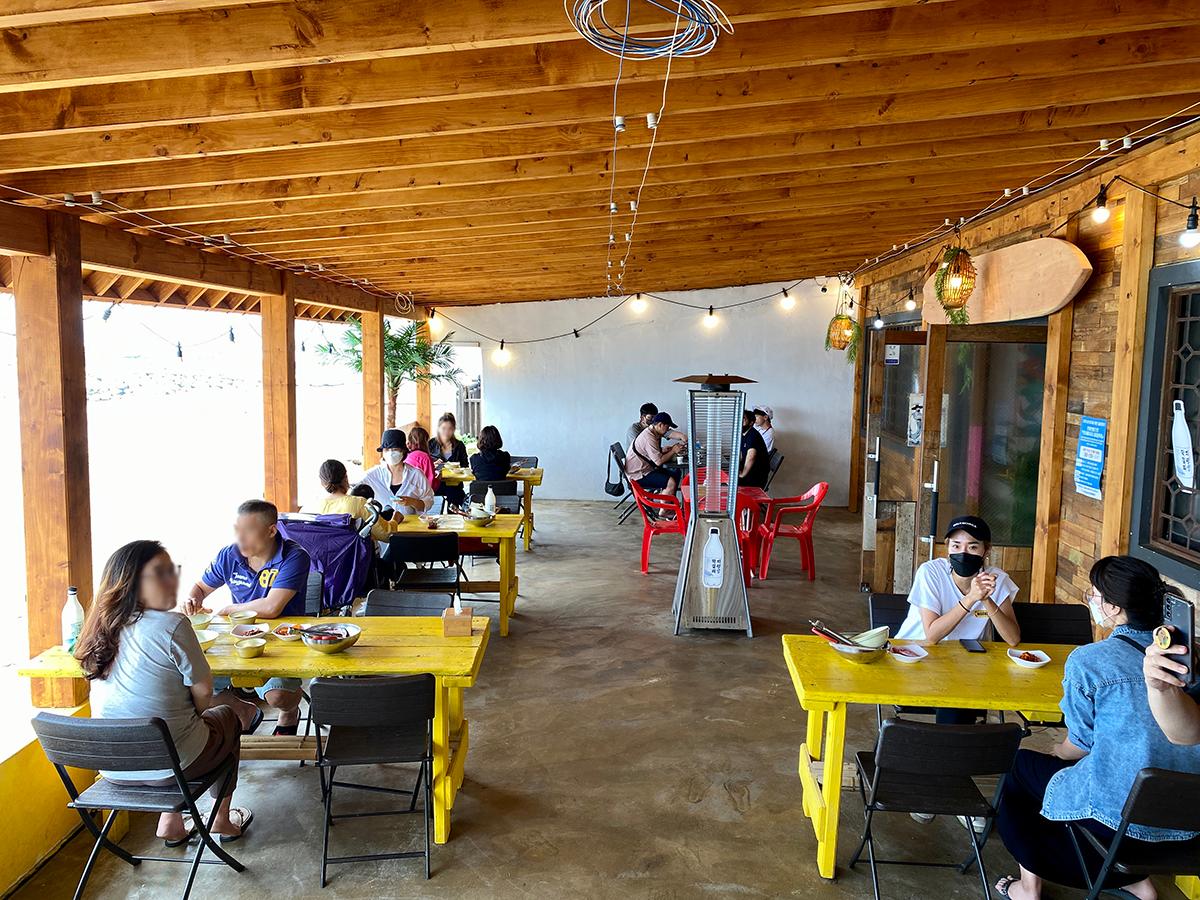 Yellow tables and red chairs inside the restaurant in Gijang, Busan