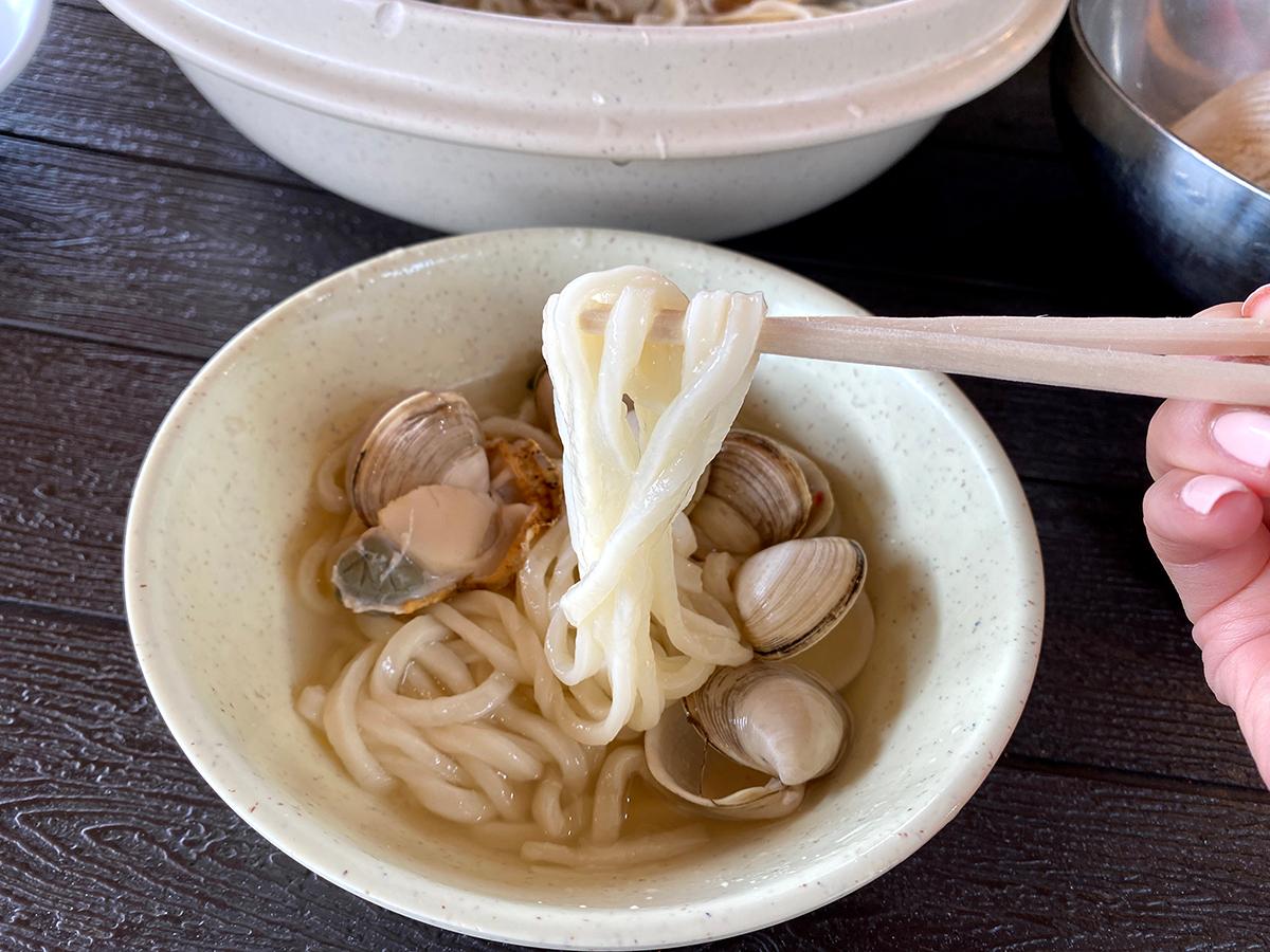 Grabbing kalguksu noodles with chopsticks