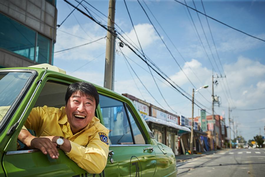A smiling taxi driver