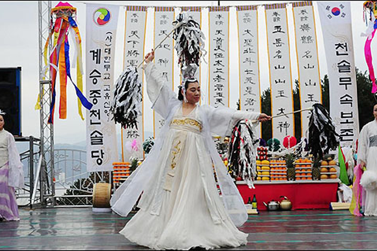 Korean shaman, mudang, performing a rite in white clothes
