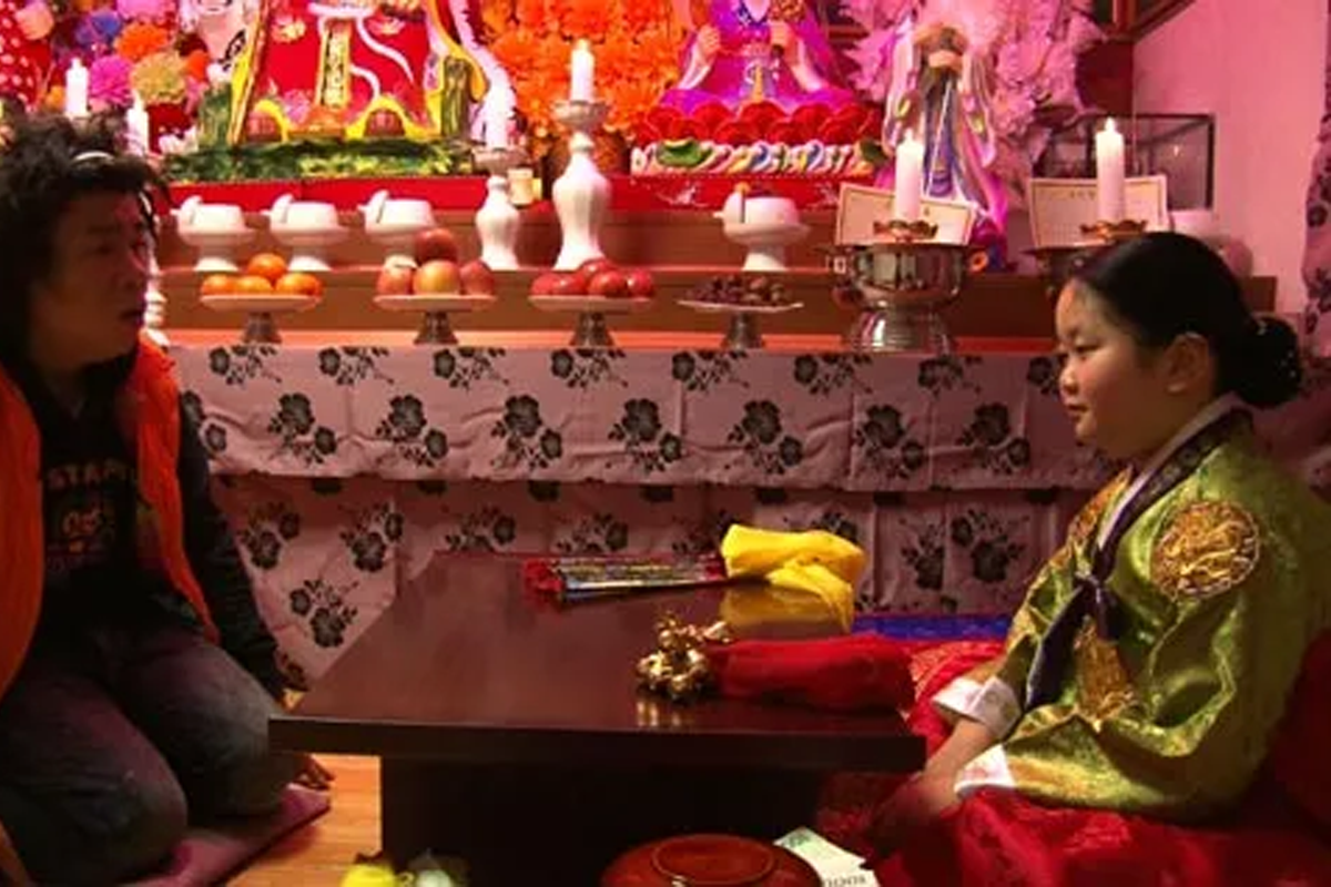 Young Korean shaman (mudang) sitting down