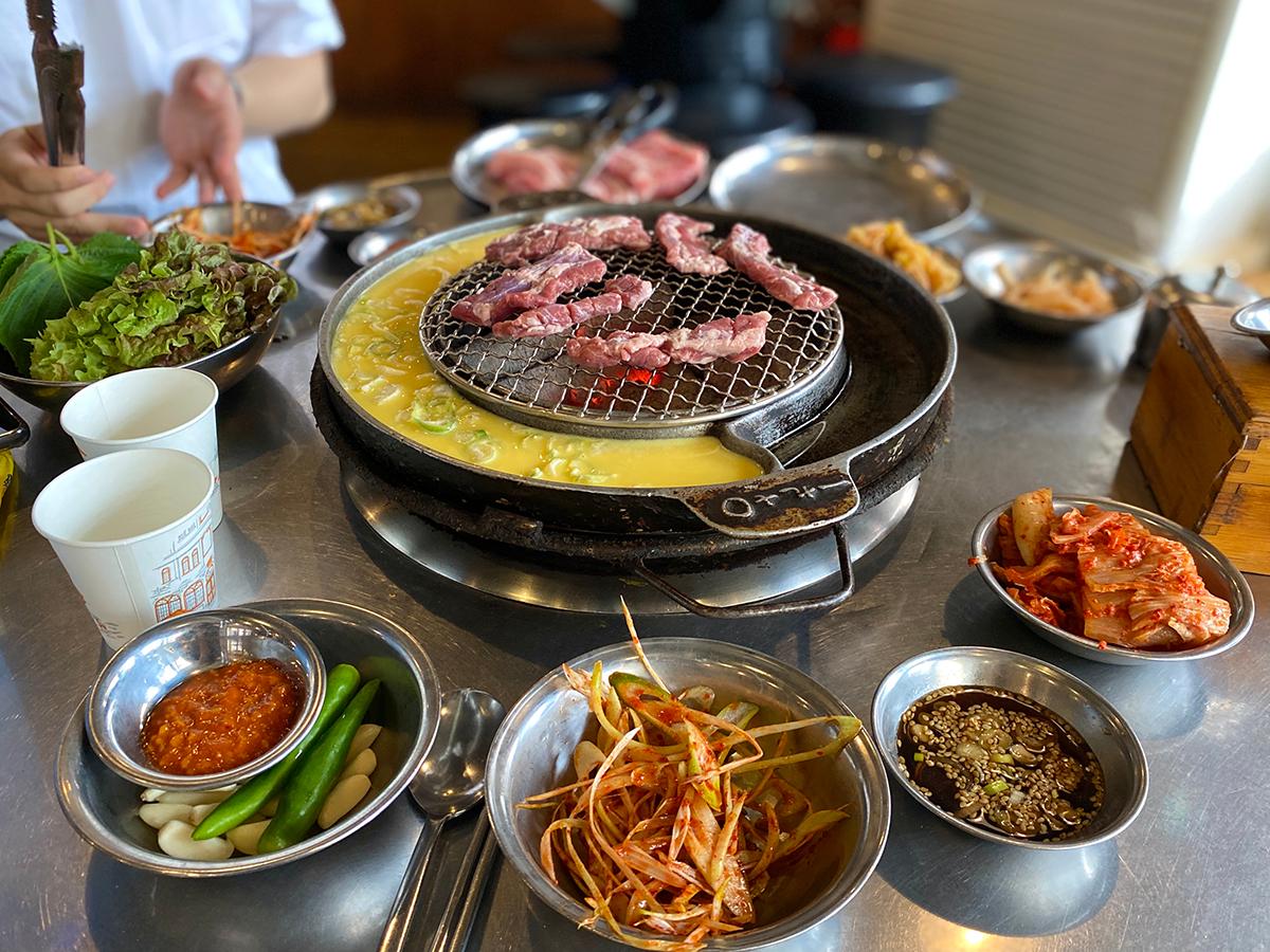 Korean barbecue grill surrounded by many side dishes in Haeundae, Busan