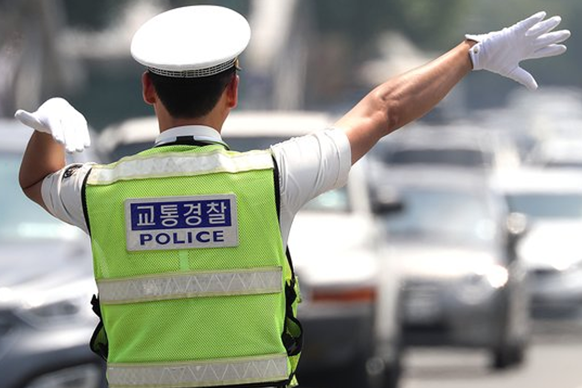 Korean police officer outside directing traffic