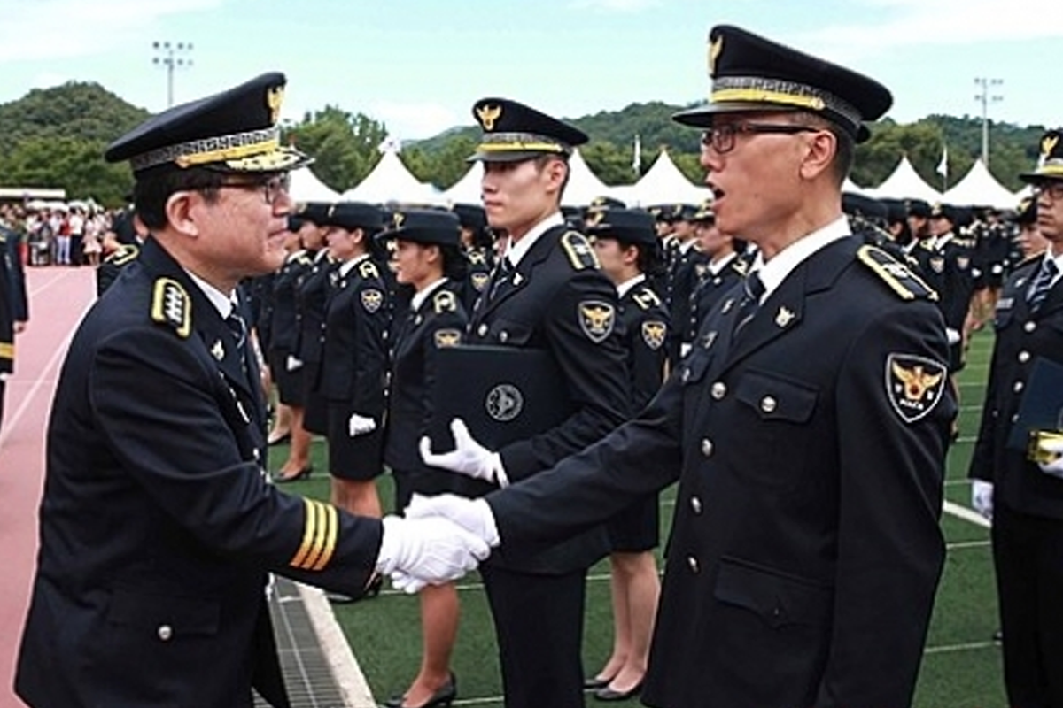 Korean police officer outdoor promotion ceremony, handshake, uniform
