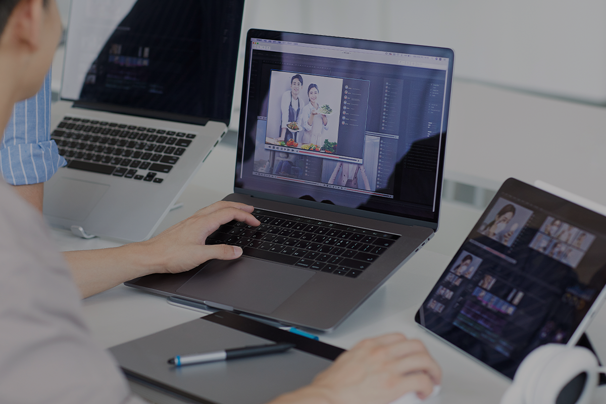 Korean man on their desk editing video on Mac