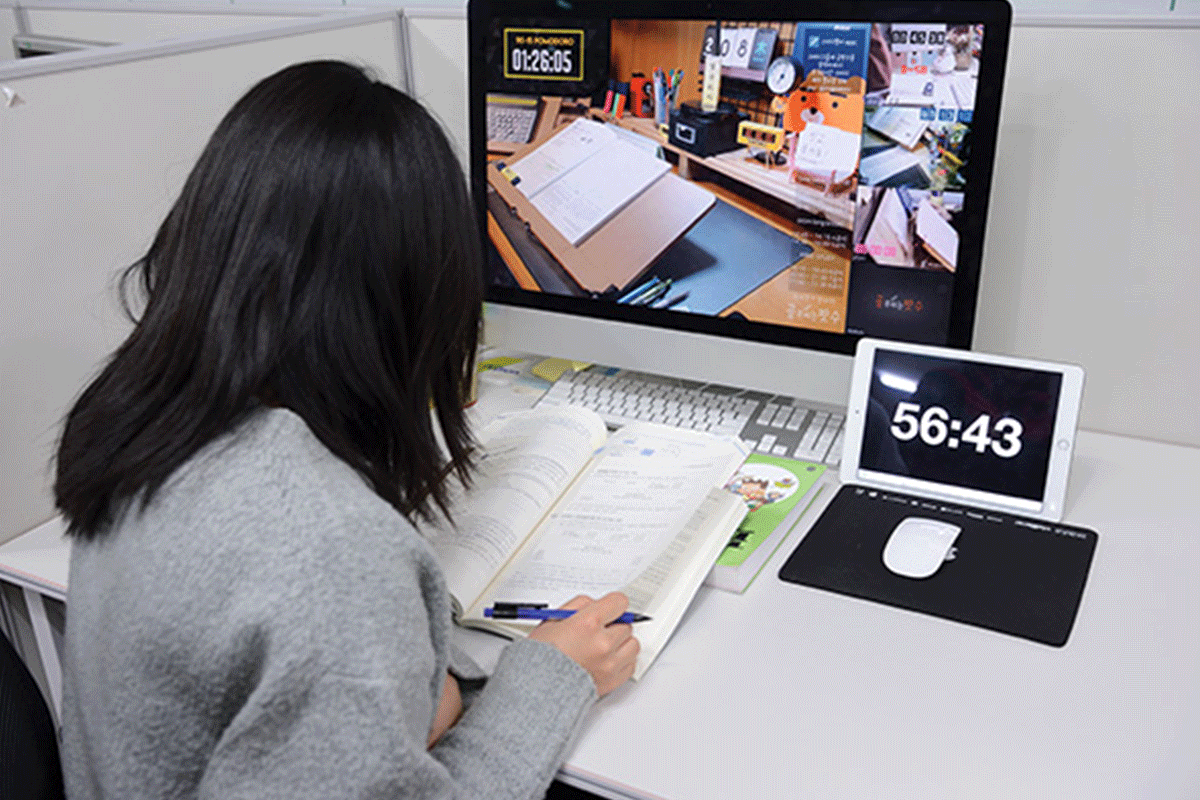 Korean student studying at her desk with her virtual study group